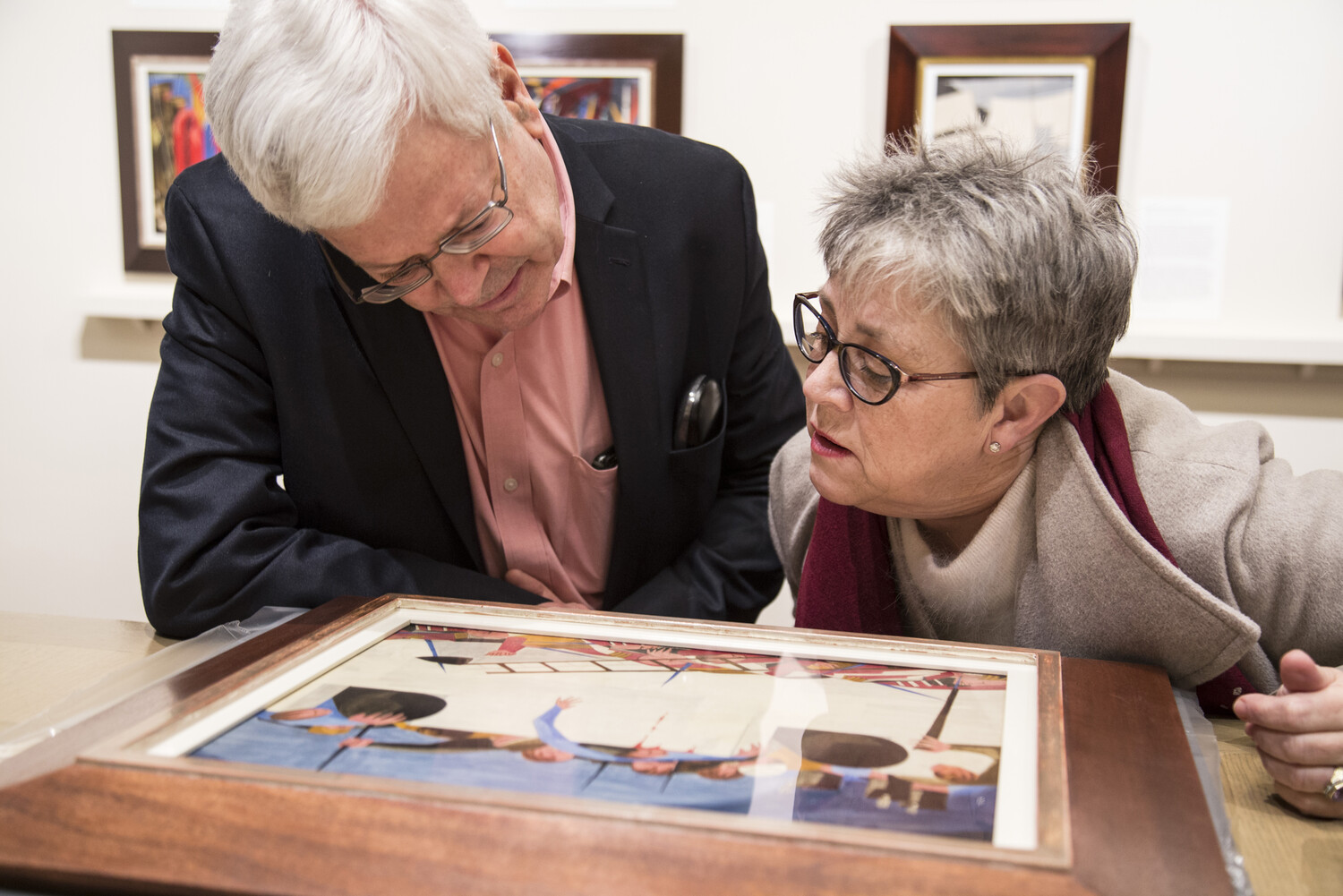 Prof. Beth Turner and collector Harvey Ross examining Panel 25 under glass after conservation; background Panel 24 installed in The Fralin print study gallery Spring 2016