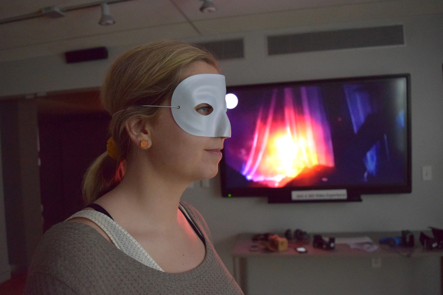 Woman looking at a screen with a mask