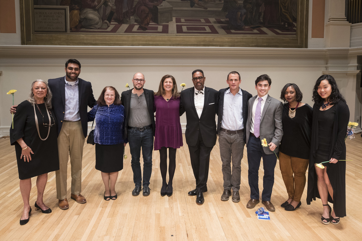 Double Take participants – including Rehan Baddeliyanage, second from the left and President Jim Ryan, fourth from right – gather onstage in the Old Cabell Hall Auditorium. The storytelling event capped Inauguration Weekend activities.