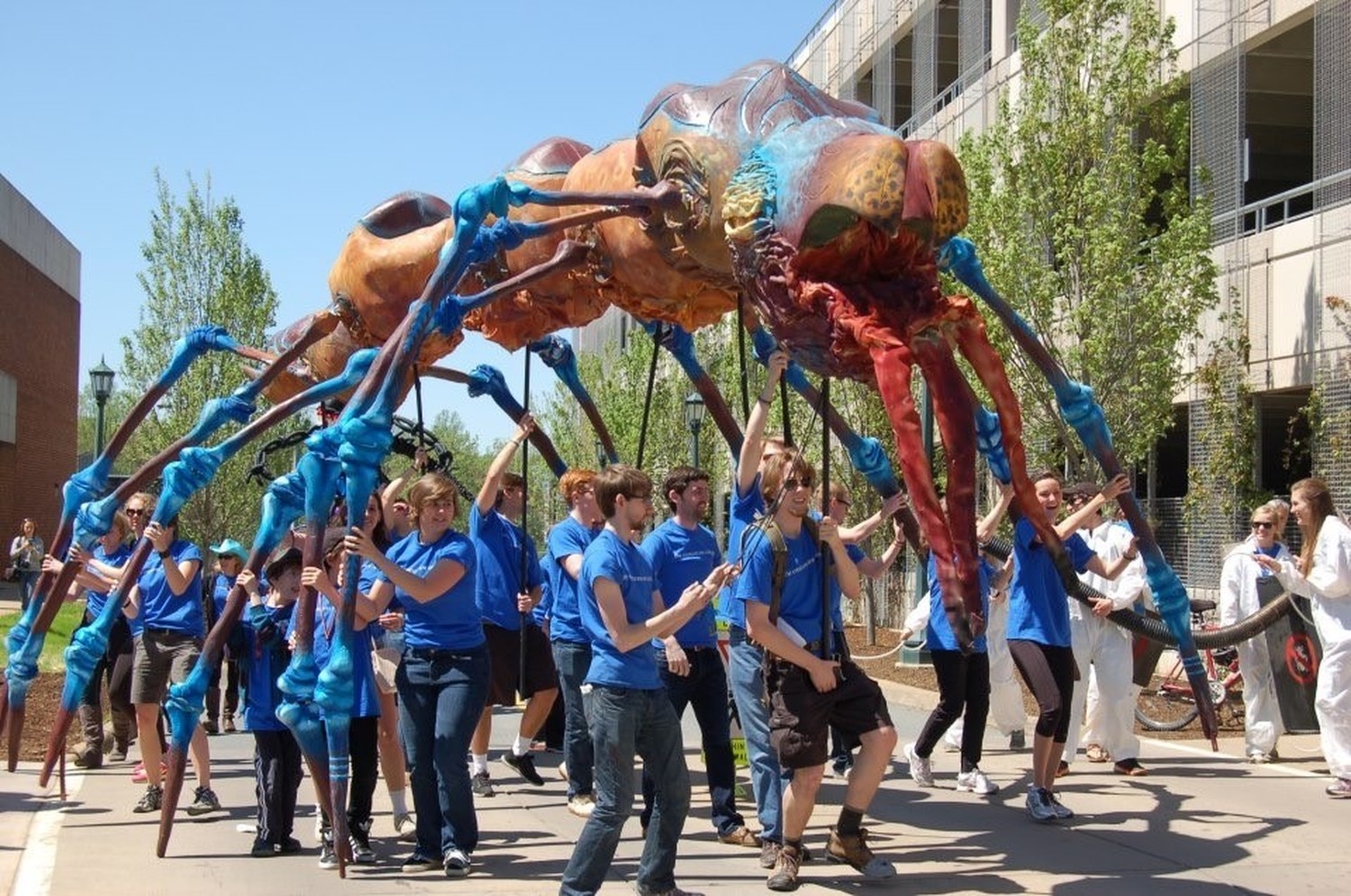 Students carrying Winston during the Festival of the Moving Creature parade