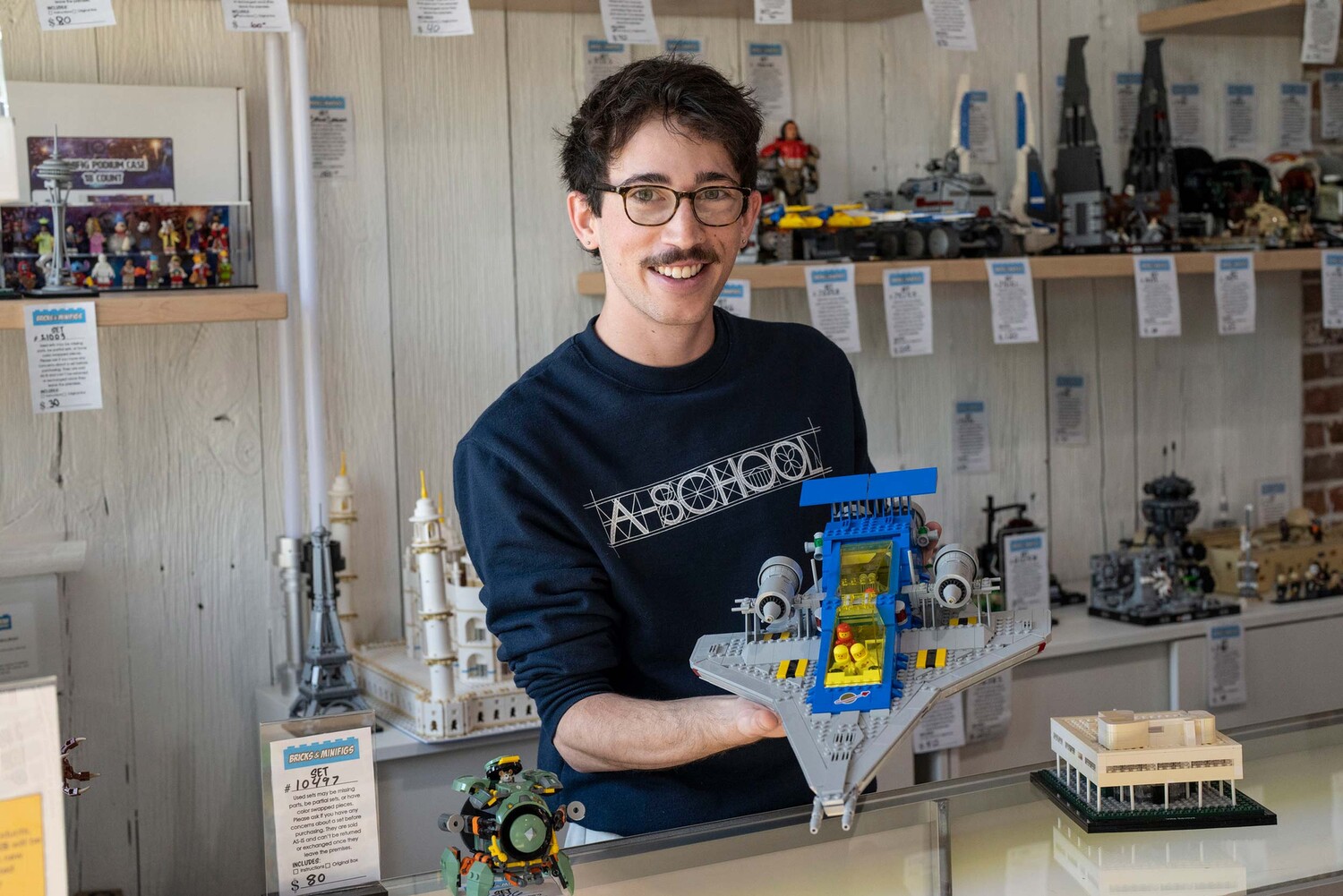 Edlavitch shows off a Lego build at Charlottesville’s new store, Bricks and Minifigs, located at The Shops at Stonefield. (Photo by Dan Addison, University Communications)