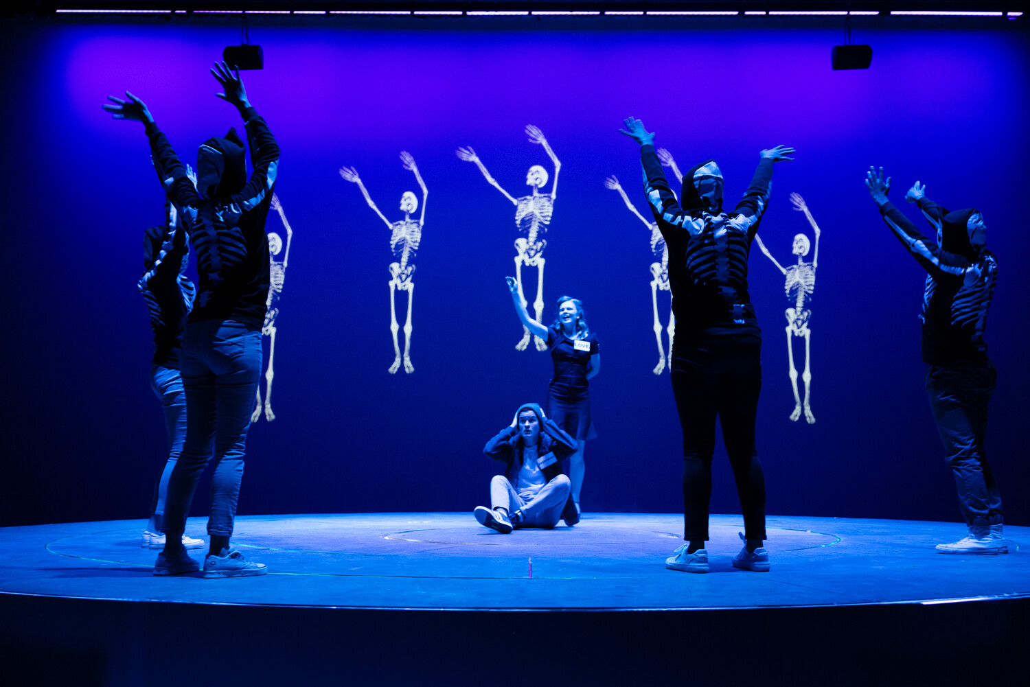 Skeletons (Mary Hall, Darnell Glover, Katia Ramirez, and Lilla Woodard) come alive in the Danse Macabre, surrounding Love (Meredith Hicks) and the character of Everybody (Sean Miller). Everybody, directed by Dave Dalton, Fall 2023, UVA Department of Drama. Photo by Tom Daly Photography.