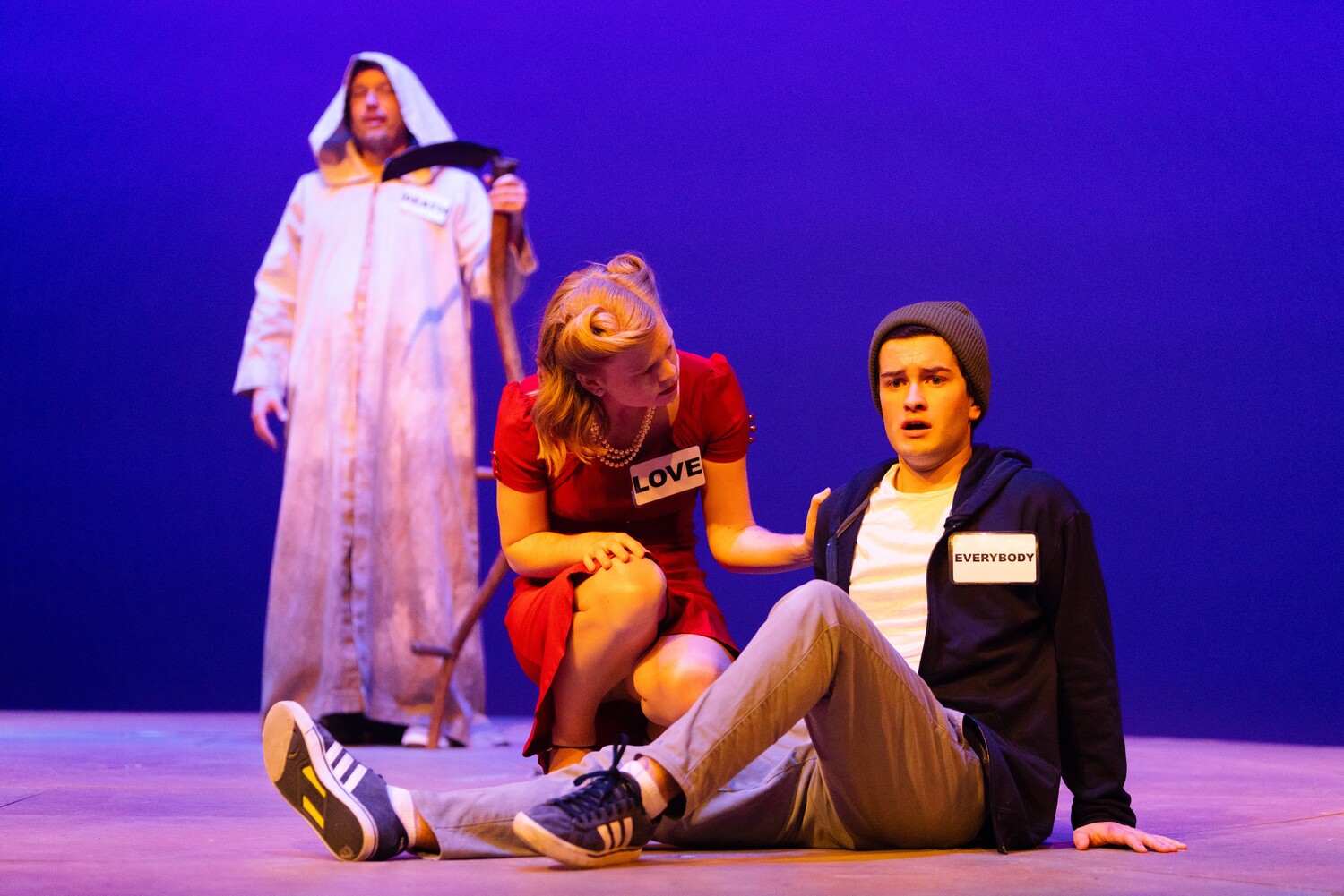 Death (Guy Aiken) looks on as Love (Meredith Hicks) tries to help the character of Everybody (Sean Miller) continue their journey. Everybody, Fall 2023, UVA Department of Drama. Photo by Tom Daly Photography.