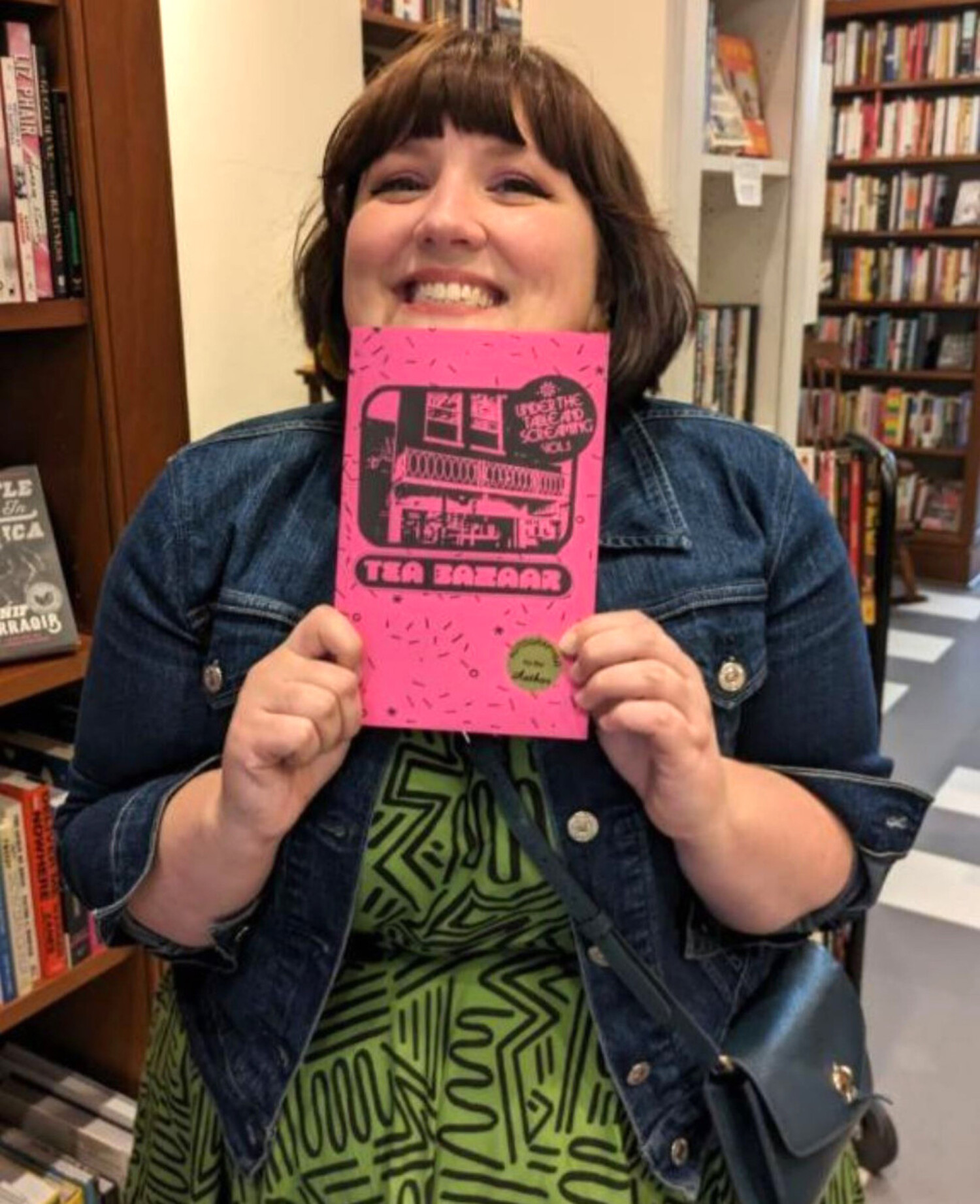 Erin O&apos;Hare with Volume 1 of Under the Table and Screaming featuring the Tea Bazaar