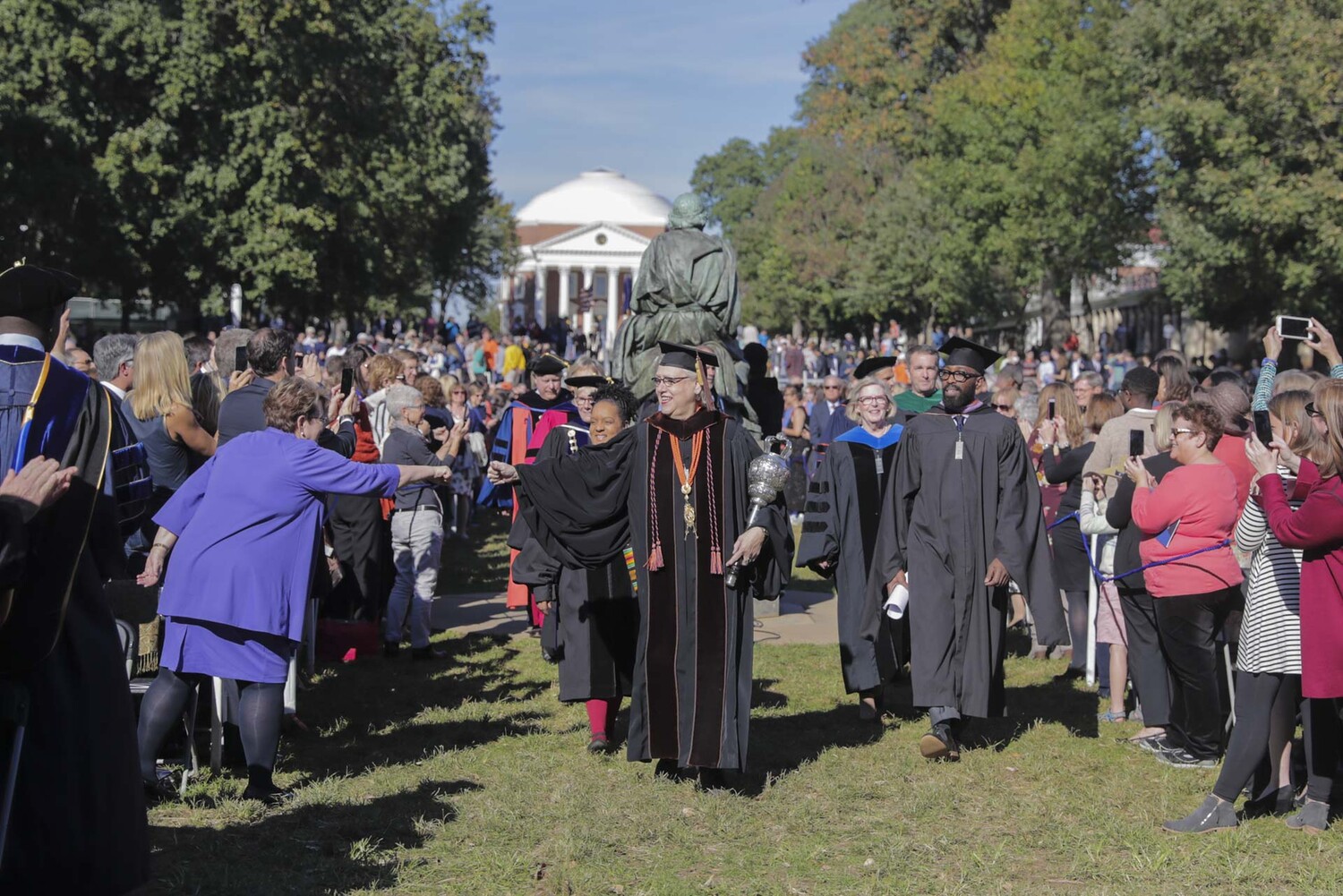 During Jim Ryan's Inauguration procession, Teresa A. Sullivan, former UVA President offered a first-bump to Professor Gweneth West, who serves as UVA’s grand marshal for Final Exercises and other seminal University events.
