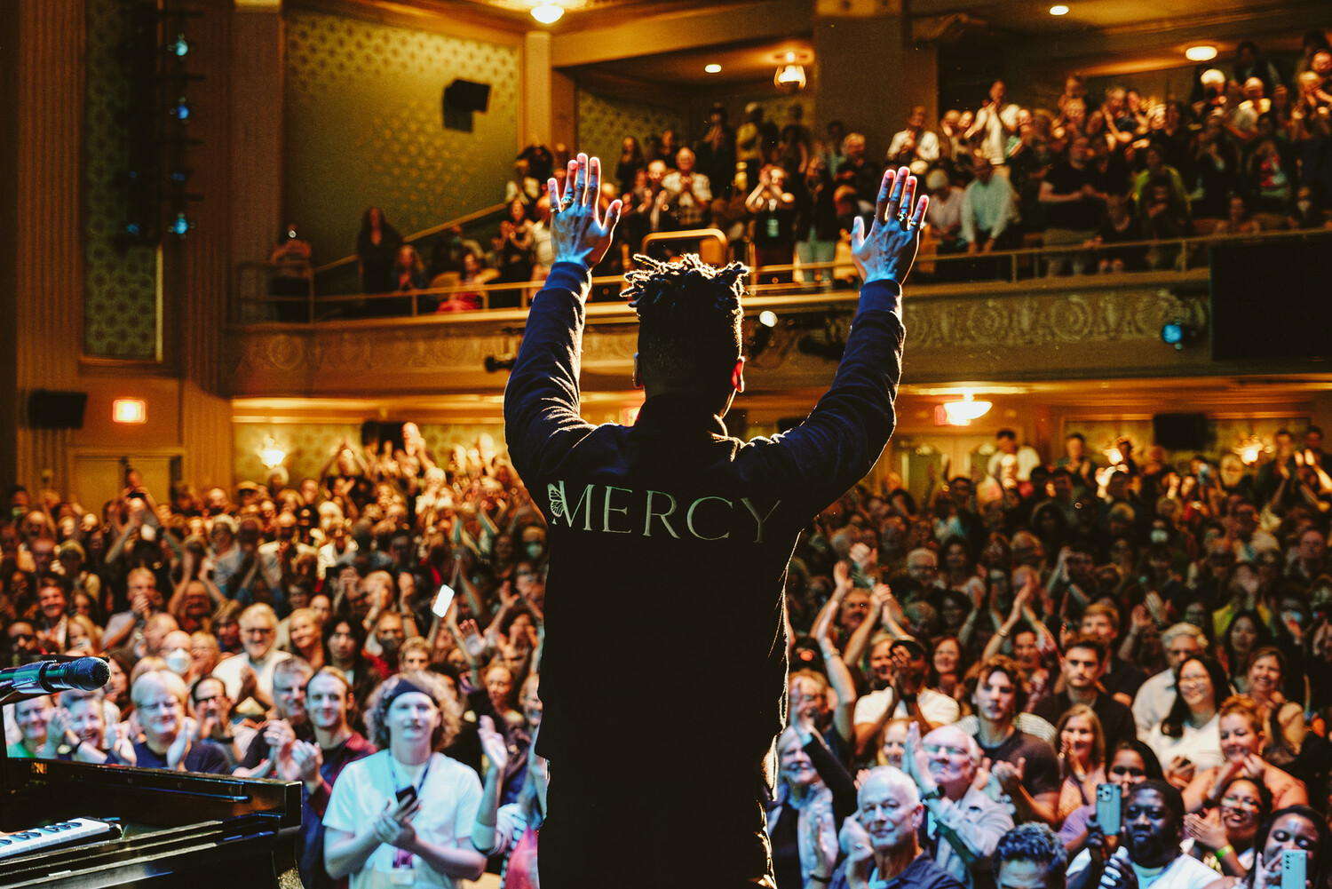 Jon Batiste takes a bow to a standing ovation on stage at The Paramount following the screening of American Symphony and a live performance at the 2023 Virginia Film Festival.